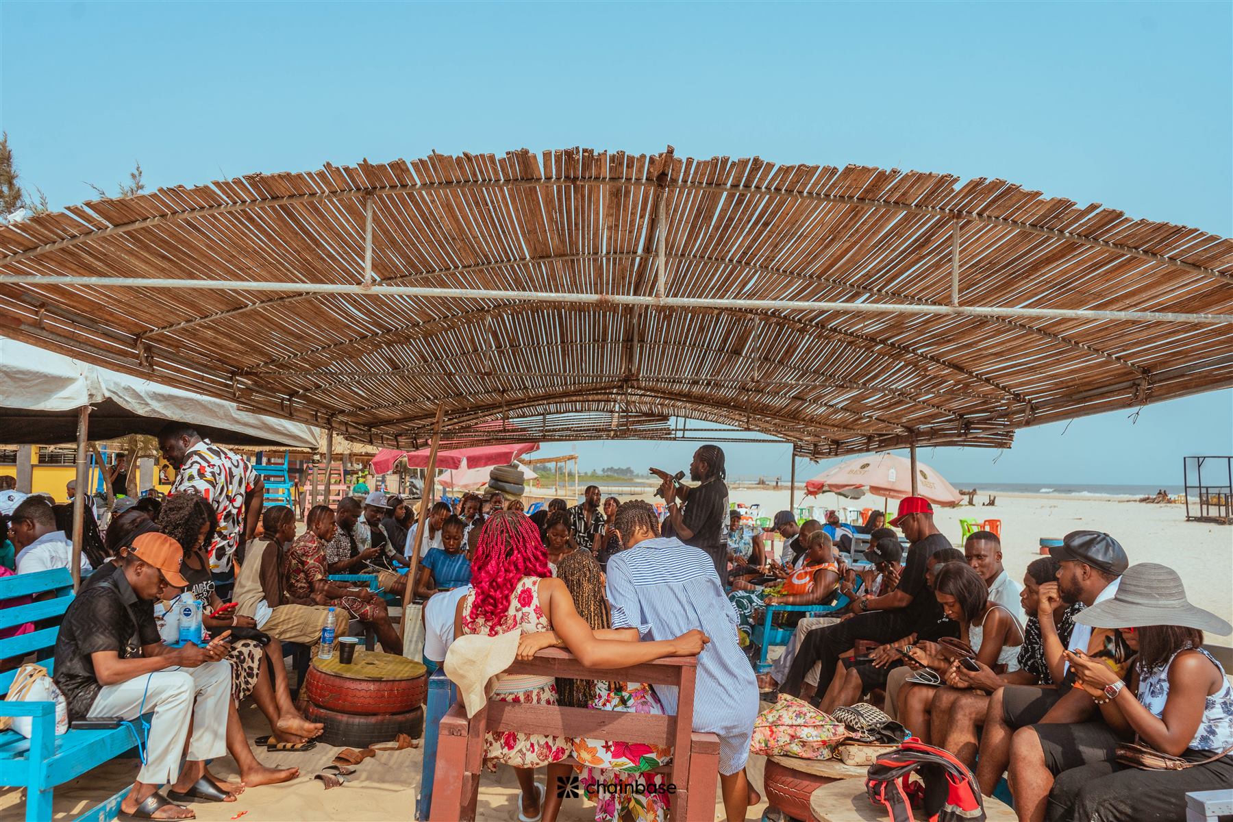 The Chainbase Beachfest crowd seated under the beach canopy