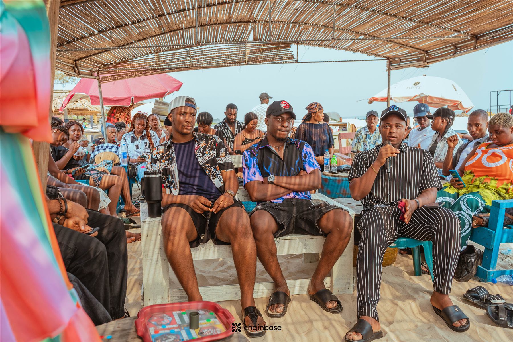 A speaker addressing the crowd on the microphone at Chainbase Beachfest