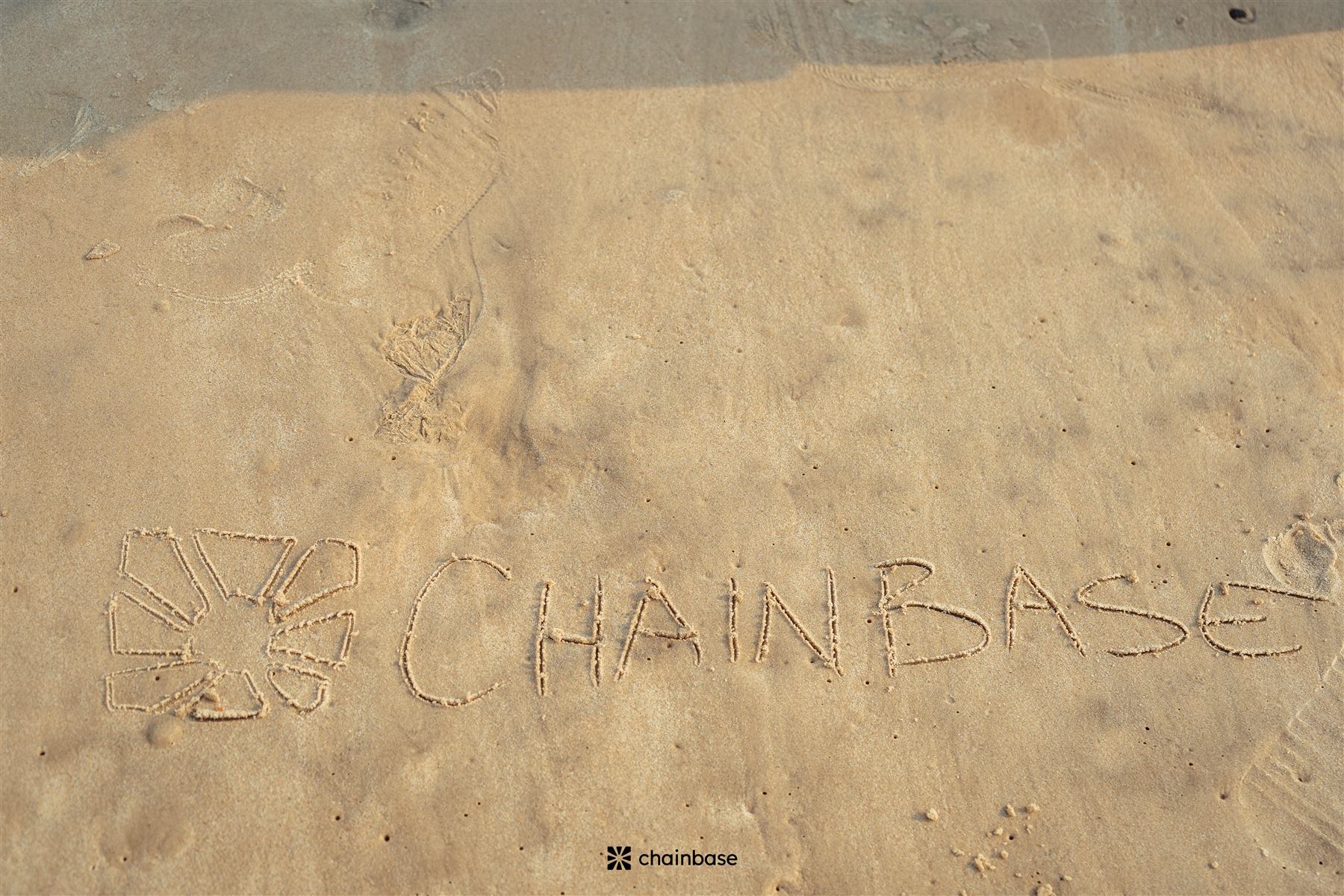 The Chainbase name and logo written in the sand at Beachfest