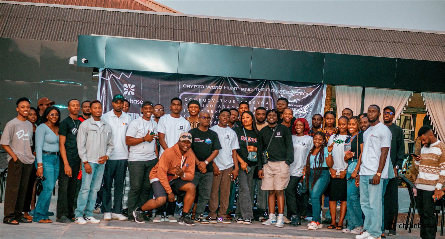 Guests gathered in front of the Chainbase banner at the Mixer Party