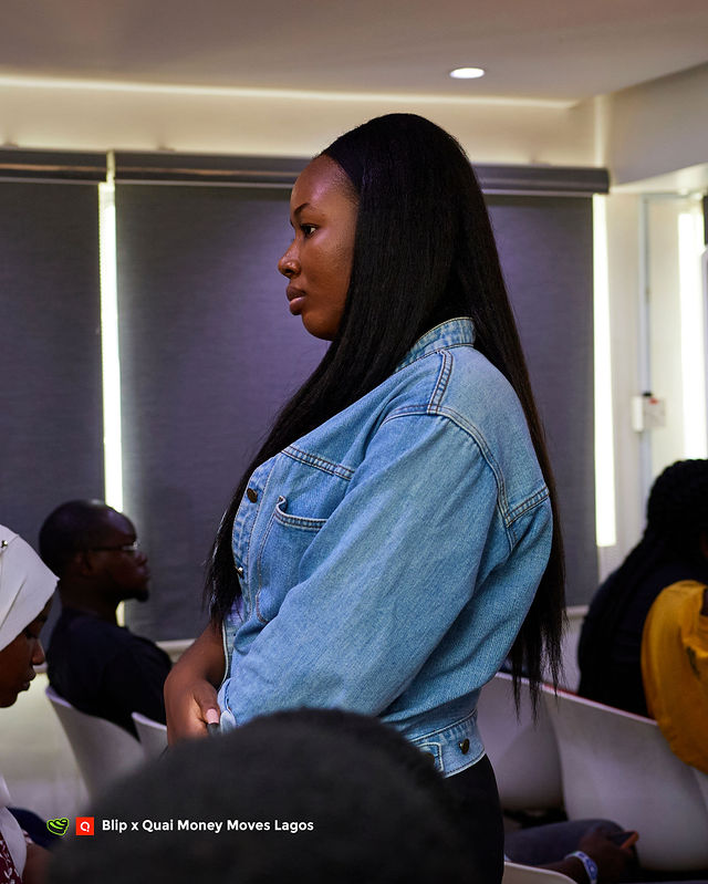An attendee listening during the Money Moves Lagos programme