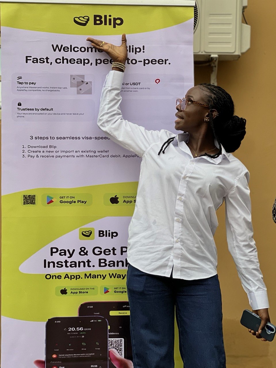 A presenter at the Money Moves Uyo Blip banner, explaining the app to the room